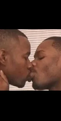 Two black men kissin