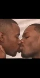 Two black men kissin